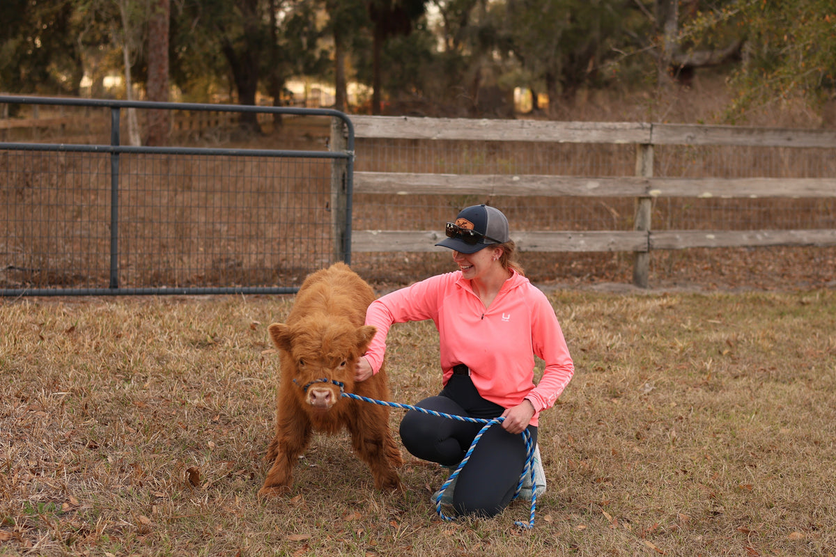 Guest spending time with Scottish Highland cattle at Rye Meadow Ranch